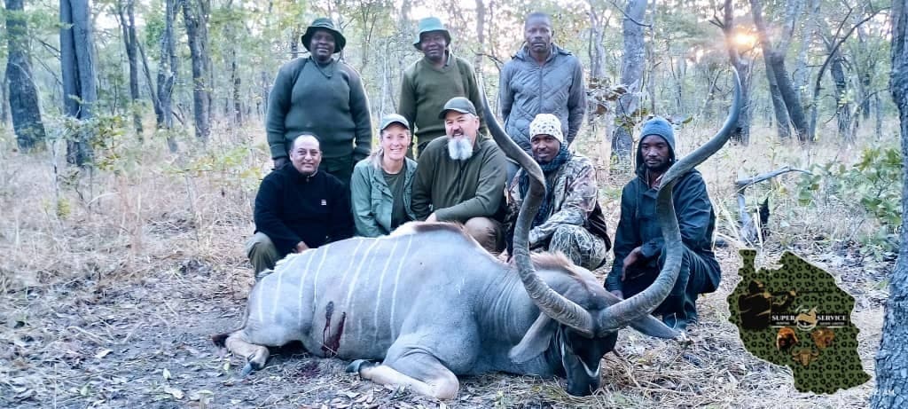 Group of hunters and TAWA scouts with giant eland, Rungwa North Tanzania