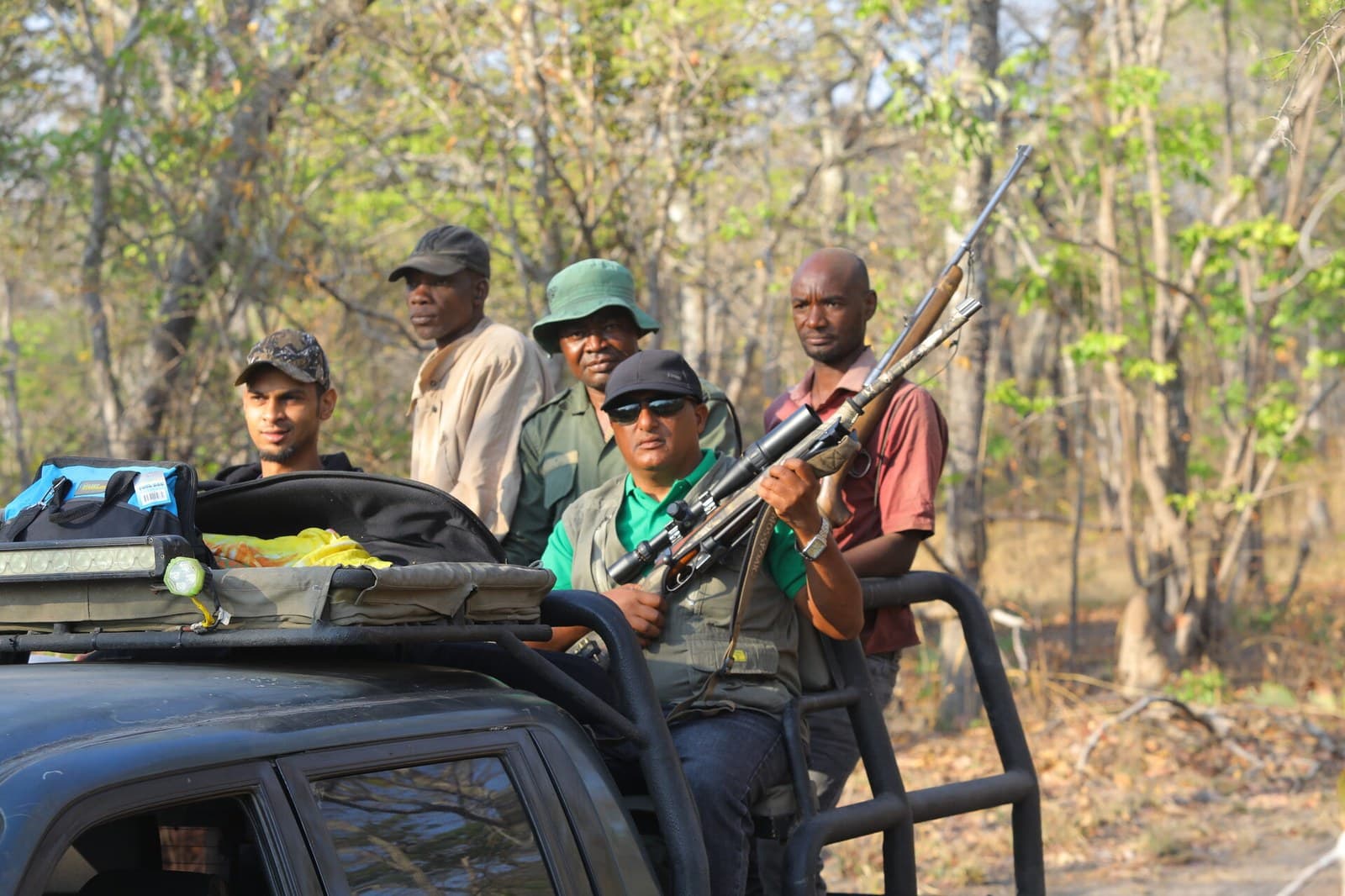 Hunting team on Land Cruiser in Rungwa North open forest Tanzania with TAWA game scouts